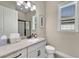 Bathroom boasts a granite countertop, white cabinets, and a walk-in shower at 3875 Grassland Loop, Lake Mary, FL 32746