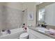 Bathroom includes a shower/tub combo, granite countertop, and white vanity at 3875 Grassland Loop, Lake Mary, FL 32746