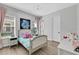 Charming bedroom with light gray walls and a white upholstered bed at 3875 Grassland Loop, Lake Mary, FL 32746