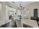 Spacious dining room with chandelier, hardwood floors, and views to living room at 3875 Grassland Loop, Lake Mary, FL 32746