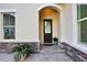 Elegant front entry with arched entryway and decorative door at 3875 Grassland Loop, Lake Mary, FL 32746