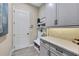 Bright laundry room with built-in cabinets, countertop, and bench at 3875 Grassland Loop, Lake Mary, FL 32746