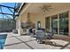 Outdoor kitchen with stainless steel appliances and seating area at 3875 Grassland Loop, Lake Mary, FL 32746