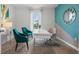 Home office with teal accent wall and modern desk setup at 4133 Giorgio Dr, Winter Haven, FL 33884