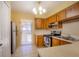 Small kitchen with wood cabinets and appliances at 79 Lake Villa Way, Kissimmee, FL 34743