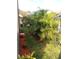 Side yard with lush landscaping and palm trees at 7947 Golden Pond Cir, Kissimmee, FL 34747