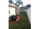 Landscaped backyard with mulch and pool equipment at 7947 Golden Pond Cir, Kissimmee, FL 34747