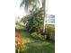 Landscaped side yard, featuring a variety of tropical plants at 7947 Golden Pond Cir, Kissimmee, FL 34747