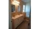 Double vanity bathroom with soaking tub and mirrors at 7947 Golden Pond Cir, Kissimmee, FL 34747