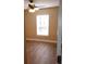Simple bedroom with hardwood flooring and a window at 7947 Golden Pond Cir, Kissimmee, FL 34747