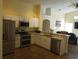 Modern kitchen with stainless steel appliances and granite countertops at 7947 Golden Pond Cir, Kissimmee, FL 34747