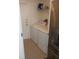 Bright laundry room, featuring washer, dryer, and shelving at 7947 Golden Pond Cir, Kissimmee, FL 34747