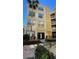 Three-story building with yellow exterior and landscaping at 860 N Orange Ave # 118, Orlando, FL 32801