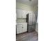 Modern kitchen with stainless steel refrigerator and white cabinets at 860 N Orange Ave # 118, Orlando, FL 32801