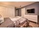 Guest bedroom with a dresser and a stylish bedspread at 8929 Amelia Downs Trl, Kissimmee, FL 34747