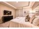 Comfortable bedroom with a king-size bed and a large TV at 8929 Amelia Downs Trl, Kissimmee, FL 34747