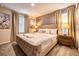 Spacious bedroom with upholstered bed and window treatments at 8929 Amelia Downs Trl, Kissimmee, FL 34747