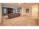 Open living area with a sofa and neutral carpeting at 8929 Amelia Downs Trl, Kissimmee, FL 34747