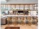 Elegant community bar with a marble countertop and gold barstools at 8929 Amelia Downs Trl, Kissimmee, FL 34747
