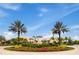 Community entrance with lush landscaping and fountain at 8929 Amelia Downs Trl, Kissimmee, FL 34747