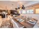 Elegant dining room with a glass-top table and modern light fixtures at 8929 Amelia Downs Trl, Kissimmee, FL 34747