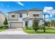 Two-story house with light-colored siding, a three-car garage, and landscaping at 8929 Amelia Downs Trl, Kissimmee, FL 34747