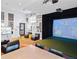 Clubhouse game room features a golf simulator and a large screen at 8929 Amelia Downs Trl, Kissimmee, FL 34747