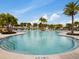 Relaxing resort-style pool with plenty of lounge chairs at 8929 Amelia Downs Trl, Kissimmee, FL 34747