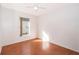 Well-lit bedroom with wood-look floors and a window with natural light at 11825 Cranbourne Dr, Orlando, FL 32837