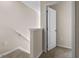 Upstairs hallway with a door to a room and staircase at 1972 Tamarack Rd, Davenport, FL 33837