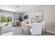 Modern dining area with white round table and chairs, and access to the patio at 2211 Longleaf Rd, Davenport, FL 33837