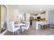 Open concept dining area with white table and chairs adjacent to kitchen at 2211 Longleaf Rd, Davenport, FL 33837