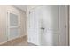 Hallway with white doors and neutral carpeting at 2211 Longleaf Rd, Davenport, FL 33837
