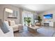 Relaxing living room with a large TV and plenty of natural light at 2211 Longleaf Rd, Davenport, FL 33837