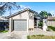 Gray garage door and walkway leading to the house entrance at 2216 Greenview Cir, Orlando, FL 32808