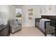 Bright Bedroom with crib, armchair, and window at 325 River Front Way, Edgewater, FL 32141