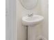 Small pedestal sink and vanity in a light-colored bathroom at 4421 Small Creek Rd, Kissimmee, FL 34744