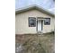 Rear view of a renovated brick house with new windows and door at 569 Loomis Ave, Daytona Beach, FL 32114