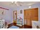 Cozy bedroom with two cribs and built-in shelving at 600 Northern Way # 1608, Winter Springs, FL 32708