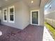 Covered front porch with brick pavers and a dark green front door at 632 Bayern Ln, Debary, FL 32713