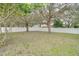 Fenced backyard with mature trees and a grassy area at 9032 Oak Moss Dr, Orlando, FL 32832