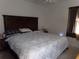 Main bedroom with king-size bed and dark wood headboard at 110 Cypress Woods Ct # 5C, Deltona, FL 32725