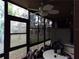 Screened-in patio with table and chairs, overlooking trees at 110 Cypress Woods Ct # 5C, Deltona, FL 32725
