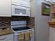 Modern electric cooktop and microwave in the kitchen at 110 Cypress Woods Ct # 5C, Deltona, FL 32725