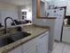 Bright kitchen with granite countertops and white cabinets at 110 Cypress Woods Ct # 5C, Deltona, FL 32725
