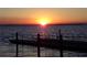 Vibrant sunset over calm lake with dock at 110 Cypress Woods Ct # 5C, Deltona, FL 32725