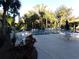 Community pool with lounge chairs and umbrellas at 110 Cypress Woods Ct # 5C, Deltona, FL 32725