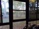 Sunroom with view of tranquil backyard and trees at 110 Cypress Woods Ct # 5C, Deltona, FL 32725