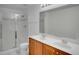 Bright bathroom boasts double vanity, large mirror, and shower at 12755 Oulton Cir, Orlando, FL 32832