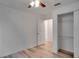 Bedroom with wood-look floors, ceiling fan, and closet at 12755 Oulton Cir, Orlando, FL 32832